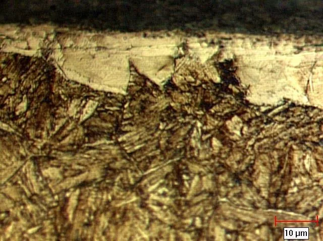 Micrograph showing severe decarburization with coarse grains
